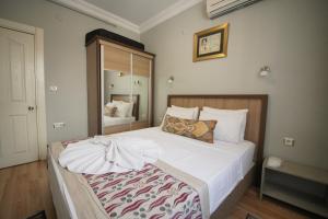 a bedroom with a large bed with white sheets at Topkapi Apartments in Istanbul