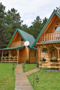 a log cabin with a green roof at Brvnare Spasić in Vinci