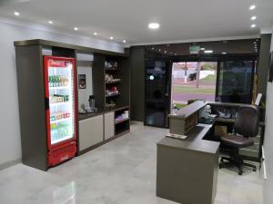 an empty salon with a cash register and a cash machine at Sleep Hotel Assis in Assis Chateaubriand