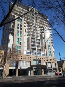 a tall white building with a lot of windows at APARTMENT@96 in Adelaide