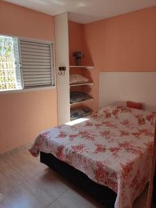 a bedroom with a bed and a window at Sarau's Beach House Boracéia in Boracéia +14 photos