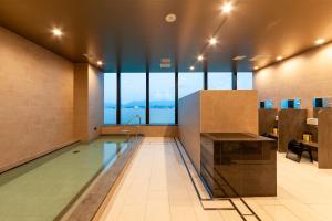 a lobby with a pool in the middle of a building at Miyako Hotel Hakata in Fukuoka