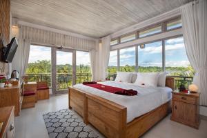 A bed or beds in a room at Abian Taksu Suite & Villas