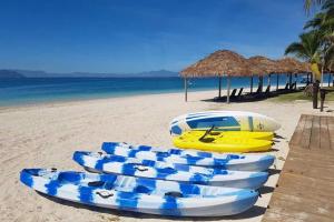 un grupo de barcos blancos y azules en una playa en Serenity Island Resort, en Bounty Island