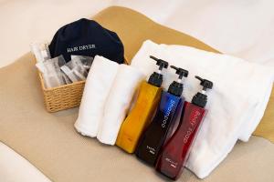 a group of towels and bottles on a table at Stay SAKURA Tokyo ASAKUSA ART DECO HOTEL in Tokyo