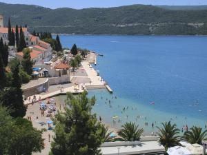 a group of people on a beach in the water at Apartments Jurković in Neum