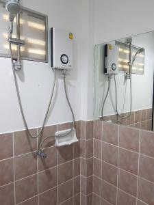 a bathroom with a shower and a mirror at ระเบียงทะเล รีสอร์ท in Phetchaburi