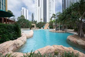 a swimming pool in a city with tall buildings at Mantra Sun City in Gold Coast
