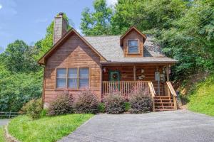 a wooden house with a driveway in front of it at Smoky Mountain Gem in Gatlinburg