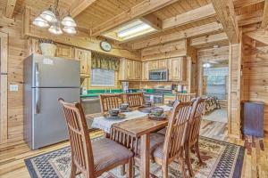 a kitchen with a table and chairs and a refrigerator at Smoky Mountain Gem in Gatlinburg