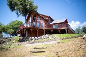 a wooden house on top of a hill at Riverfront Property with Waterfalls near Yosemite and Bass Lake in Oakhurst