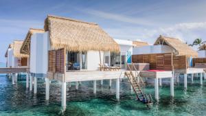 a villa on the water with a resort at Emerald Maldives Resort & Spa-Deluxe All Inclusive in Raa Atoll