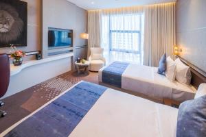 Un pat sau paturi într-o cameră la VIP Hotel Doha Qatar