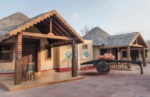 un grupo de casas con un cañón delante de ellos en Regenta Resort Bhuj by Royal Orchid Hotels Limited en Bhuj