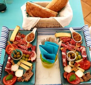 a table with two plates of food and bread at Villa des Delices in Grimaud