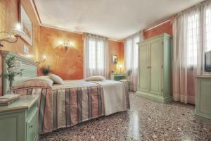 a bedroom with a bed and a painting on the wall at Hotel Firenze in Venice