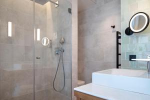 a bathroom with a shower and a sink at Hôtel des Champs-Elysées in Paris +52 photos