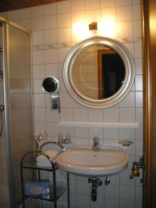 a bathroom with a sink and a mirror at Landhaus Töchterle in Telfes im Stubai +26 photos