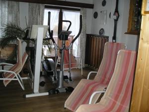 a living room with three chairs and a gym at Landhaus Töchterle in Telfes im Stubai