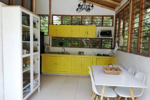 una cucina con armadi gialli e tavolo bianco di FINCA YULUKA a Apulo