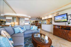 a living room with a couch and a table at Royal Kahana 409 in Lahaina