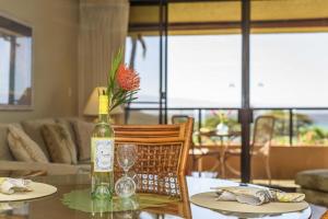 a bottle of wine sitting on top of a table at Kahana Villa F406 in Lahaina