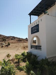 een gebouw met een bord erop in de woestijn bij Lofos Studios in Agios Prokopios
