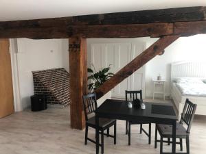 a dining room with a black table and chairs at Atelier Altstadt Stralsund in Stralsund