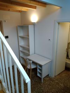 
a room with a wooden floor and a white refrigerator at Ostello S. Fosca - CPU Venice Hostels in Venice
