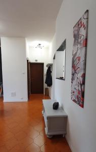 a hallway with a table and paintings on the wall at 2 bed flat Centre & Stadio free parking in Terni