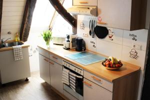 a kitchen with a counter with a bowl of fruit on it at Workers Apartment in Frickenhausen mit TV & WLAN in Frickenhausen