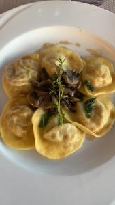 a plate of food with dumplings on a plate at Hotel & Residence La Sibilla Cusiana in Pettenasco