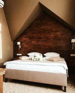 a bedroom with a large bed with a brick wall at Hotel Royal in Belgorod