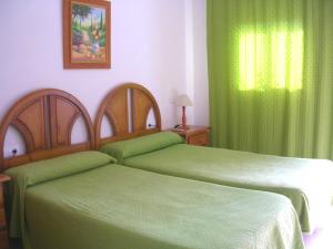 Postel nebo postele na pokoji v ubytování Hotel Antonio Conil