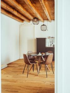 a dining room with a table and chairs at BRE Apartments - Magellano in Vicenza