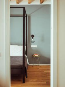 a bedroom with a bed and a table with a lamp at BRE Apartments - Magellano in Vicenza