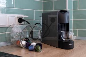 a kitchen counter with a glass bowl next to a coffee maker at MG Villas & Suites in Paleo Tsifliki