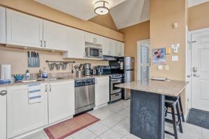 a kitchen with white cabinets and a counter top at Mountainside 2 bed 2 bath with Laundry in Blue Mountains