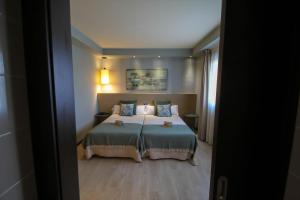 Postel nebo postele na pokoji v ubytování Hotel Torre de Núñez
