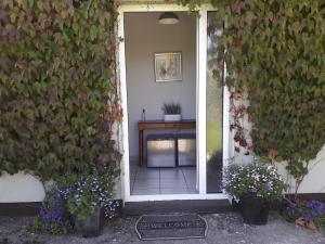 an entrance to a house with a plant covered wall at Lakeside Loughrea in Loughrea