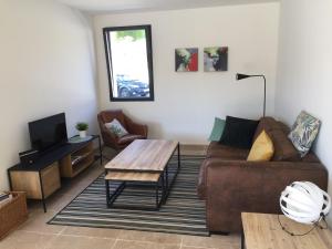 a living room with a couch and a coffee table at Mas Partout in Malaucène