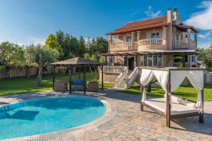 a villa with a swimming pool and a house at Villa Maxim with Private Pool & Tennis Court in Halikounas