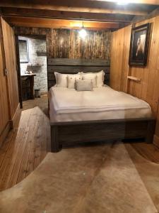 a bedroom with a large bed in a wooden room at Double G Ranch & Guestlodge in Montrose