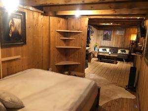 a bedroom with a bed in a room with wooden walls at Double G Ranch & Guestlodge in Montrose