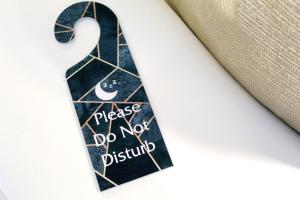 a tie with a sign that says please do not disturb at NOX Waterloo in London