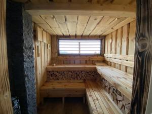 una sauna de madera vacía con una ventana en ella en Madarasi Gyopár Panzió, en Izvoare