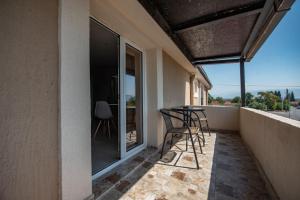 a balcony with a table and chairs on it at Studio Apartments Bulevar in Podgorica