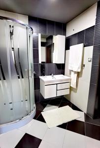 a bathroom with a sink and a shower at Hotel Acktion in Shumen +72 photos