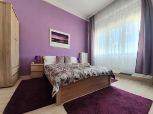 A bed or beds in a room at ABT Apartments Karoly
