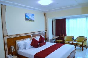 Ένα ή περισσότερα κρεβάτια σε δωμάτιο στο Empolos Hotel Nakuru